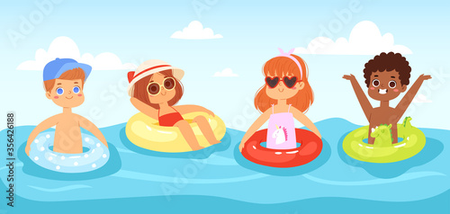 Multinational children have fun and jumping in the water. Boys and girls with inflatable rubber circles swimming in the sea. Happy kids having fun in the summer time. Landscape, panorama sea view