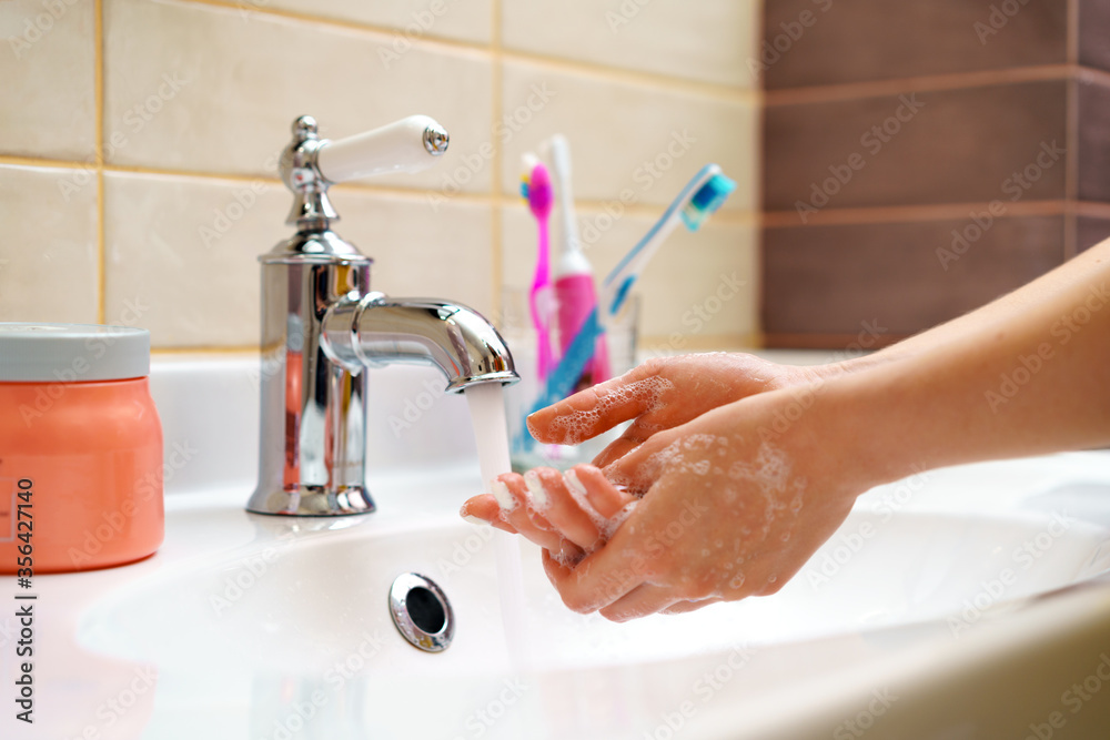 Woman washing her hands with soap close up Woman washing her hands with soap close up