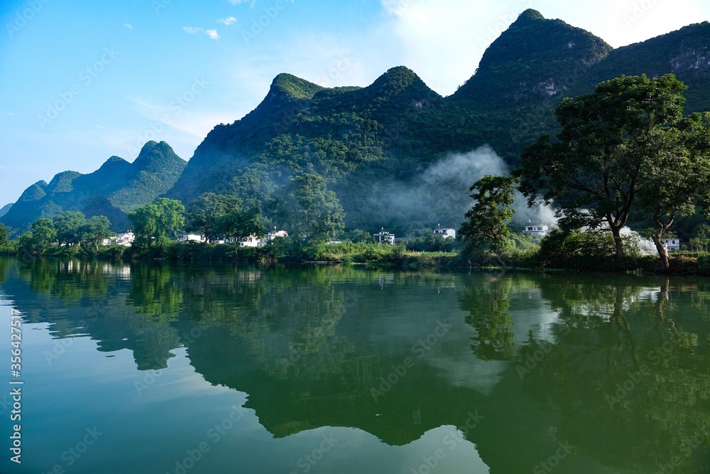 Landscape image of mountains reflected in lake