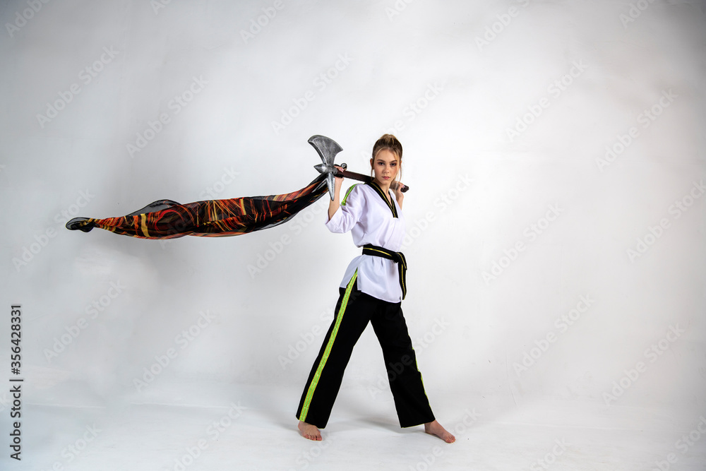 beautiful girl in a white-black suit does exercises with a battle ax and a scarf beautiful girl in a white-black suit does exercises with a battle ax and a scarf