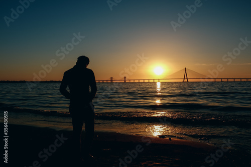 Silhouette of a man standing at a beach during Sunset in Mumbai City