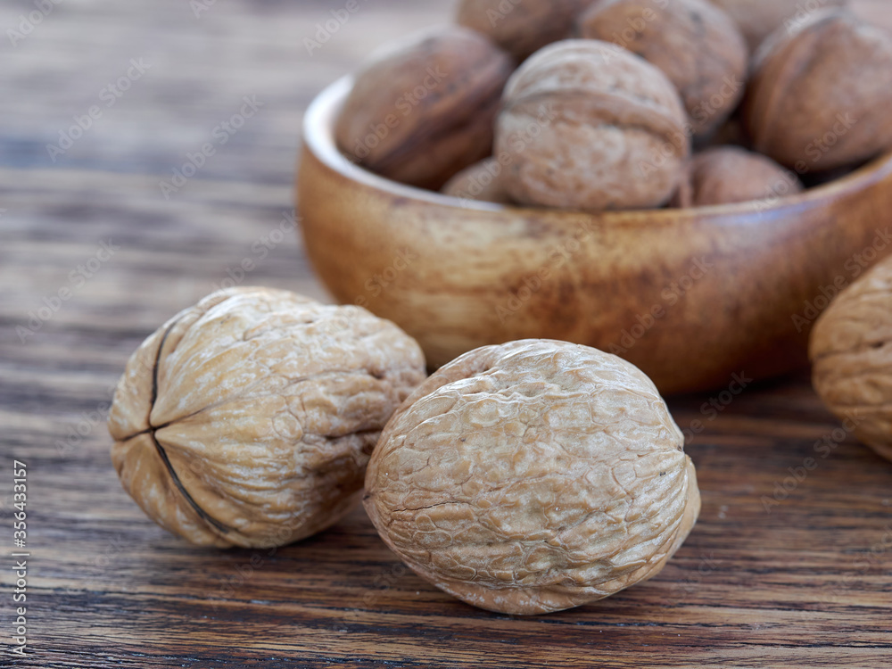 Walnuts lie on a colored wooden background.Nuts are good for your health.Vegan Walnuts lie on a colored wooden background.Nuts are good for your health.Vegan