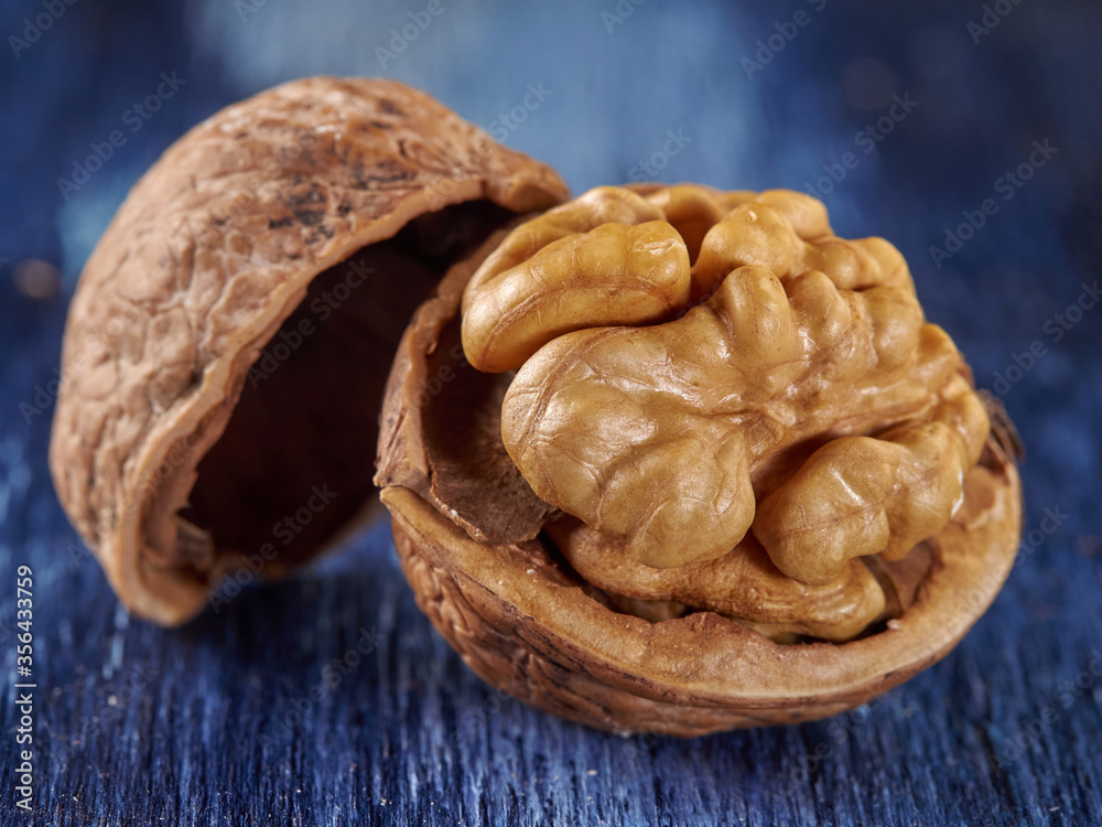 Walnuts lie on a colored wooden background.Nuts are good for your health.Vegan Walnuts lie on a colored wooden background.Nuts are good for your health.Vegan
