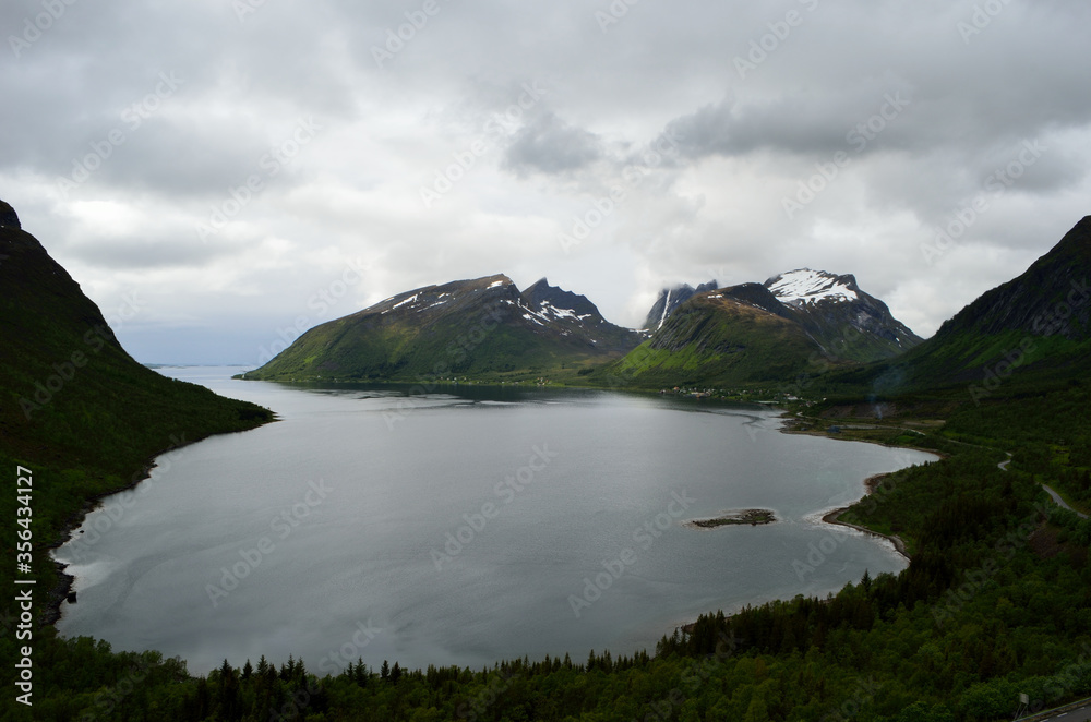 majestic fjord and mountain landscape in northern norway on a cloudy summer day