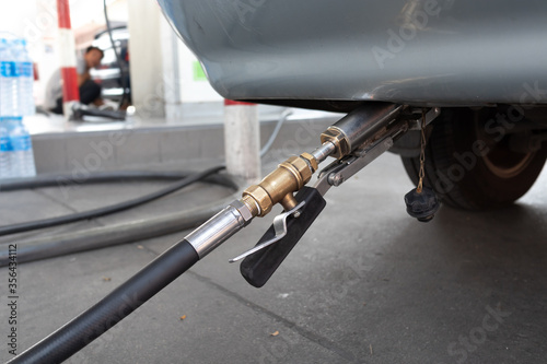 LPG refill to car in gas station.