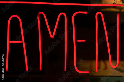 Photos Decorative neon lights, deep red, with the word amen written.