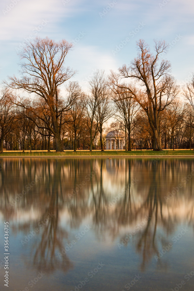Tree reflections in water with War Memorial in background, Washington D.C.