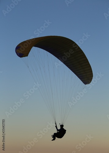 Paragliding in the clear sky