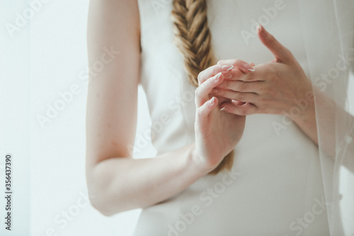Image of female manicured hands on white background