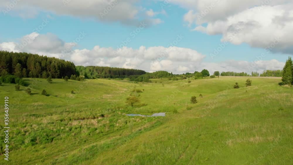 Green open field and blue sky with some clouds Green open field and blue sky with some clouds