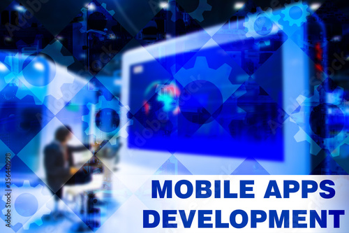 Mobile apps development. Web development training apps. Gears on background as a symbol of development process applications. Education for developer apps. Man next to big screen. Courses. IT school