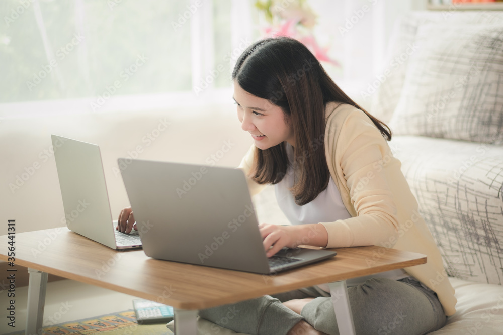 Beautiful asian woman get new normal life, social distancing. Young business woman work at home by using laptop computer, conference with happiness and smiley face Pretty girl get relax Beautiful asian woman get new normal life, social distancing. Young business woman work at home by using laptop computer, conference with happiness and smiley face Pretty girl get relax