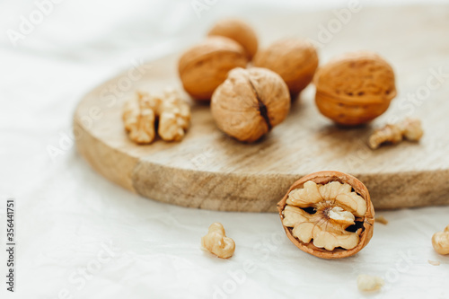Unpeeled walnuts on wooden surface, closeup.  Food photo. Selective focus.