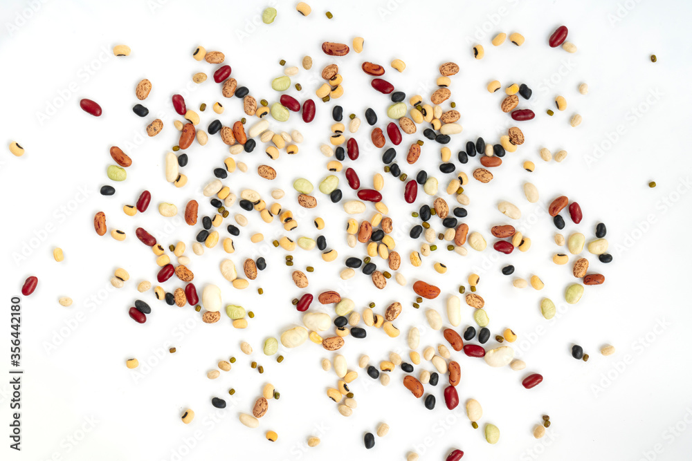 Isolated varieties of beans spread on white background, top view beautiful spread of organic mix beans. Isolated varieties of beans spread on white background, top view beautiful spread of organic mix beans.