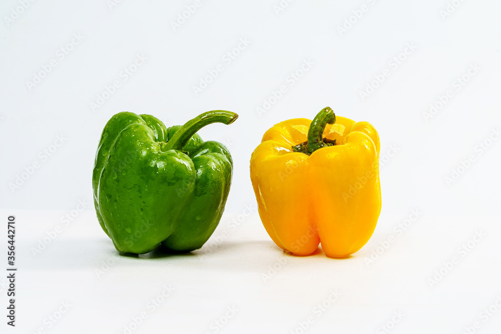 Yellow and Green Bell Pepper Wet from Water Drop on Isolated White Background. Yellow and Green Bell Pepper Wet from Water Drop on Isolated White Background.