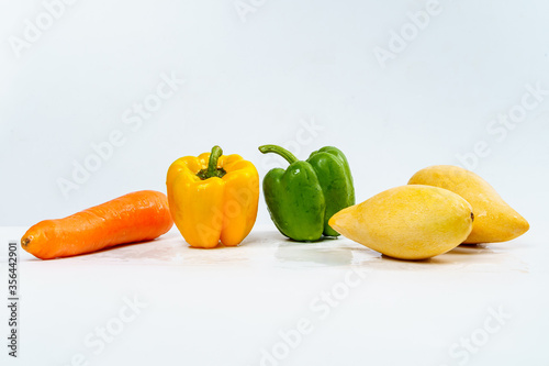 Mix Fruits for Healthy Eating, Carrot, Bell Pepper and Mangos with Water Drop on Isolated White Background.