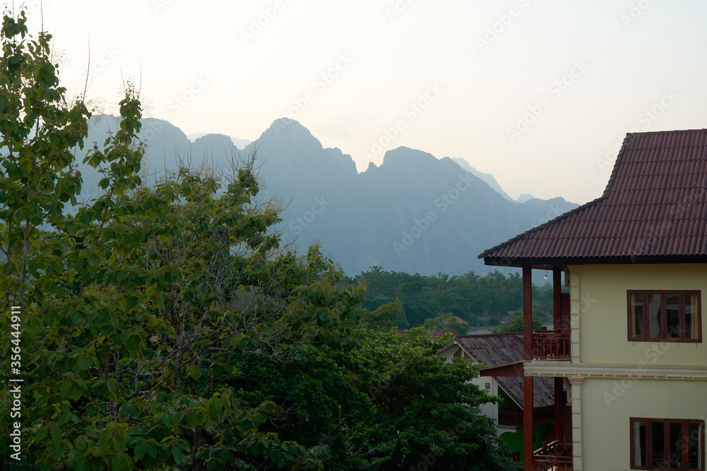 Exterior View of House Roofs and Mountainous During the Sunset in Vang Vieng, Laos. The Landscape of Unseen View of Vang Vieng.