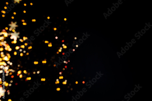 Bokeh lights on black . Beautiful Christmas background , New Year concept