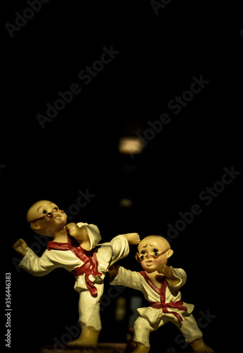 Toys playing karate in the dark background 