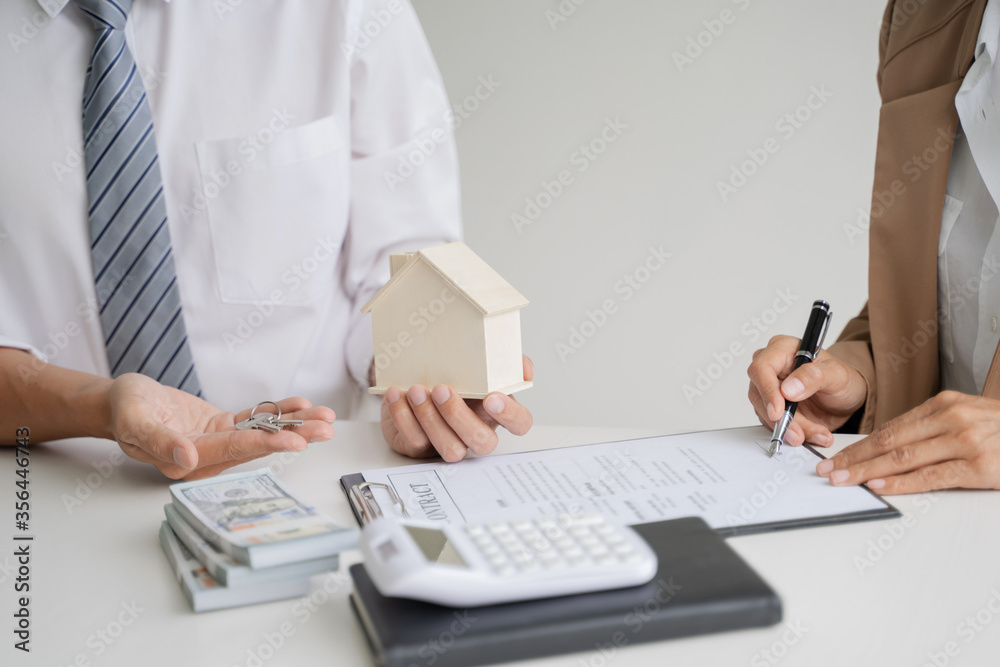 Real estate agent broker give a key with house sign contract. Real estate agent broker give a key with house sign contract.