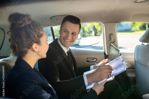 Attractive man signing document and woman in car © zinkevych