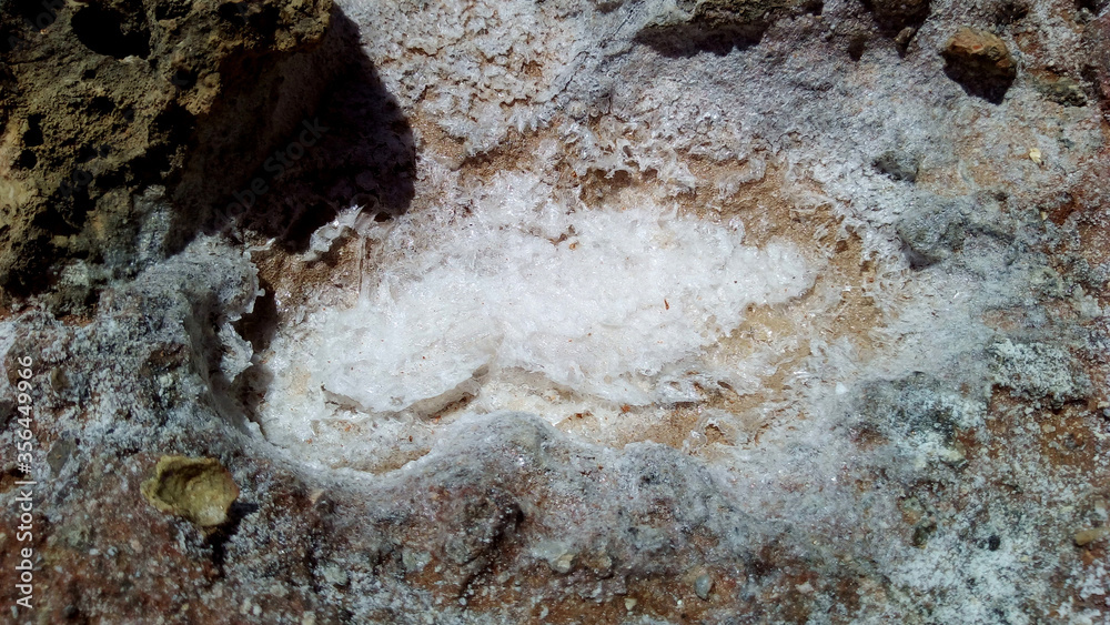 Dry puddle with salt. White crystals. Elafonisos Greece Dry puddle with salt. White crystals. Elafonisos Greece