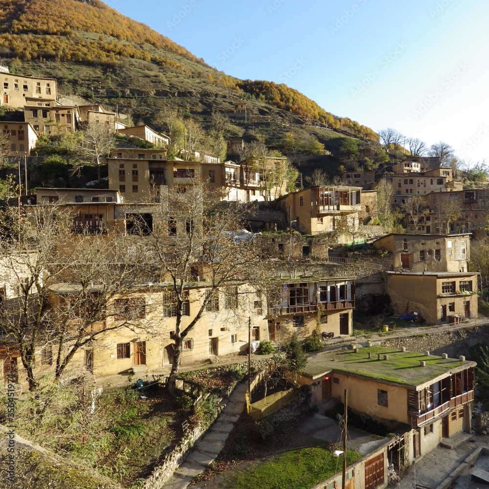 Masuleh village at Iran in sunrise  and yellow colour on autumn ,the uniq of iran architecture. The yard of the building above is the roof of the building below.