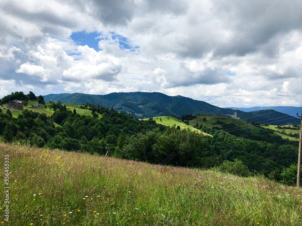 Ukrainian mountains Karpaty with cloudy sky and green trees