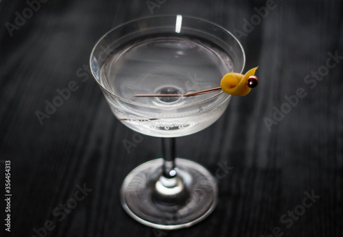 Vesper martini cocktail with a lemon peel garnish. photo