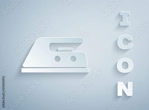 Paper cut Electric iron icon isolated on grey background. Steam iron. Paper art style. Vector Illustration.