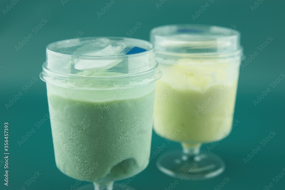 two plastic glasses with ice cream closeup two plastic glasses with ice cream closeup