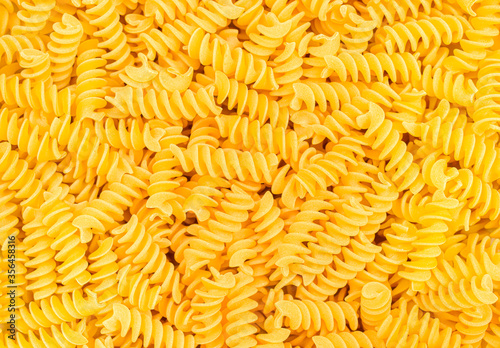 Italian Fusilli, Rotini or Scroodle Macaroni Pasta food background texture