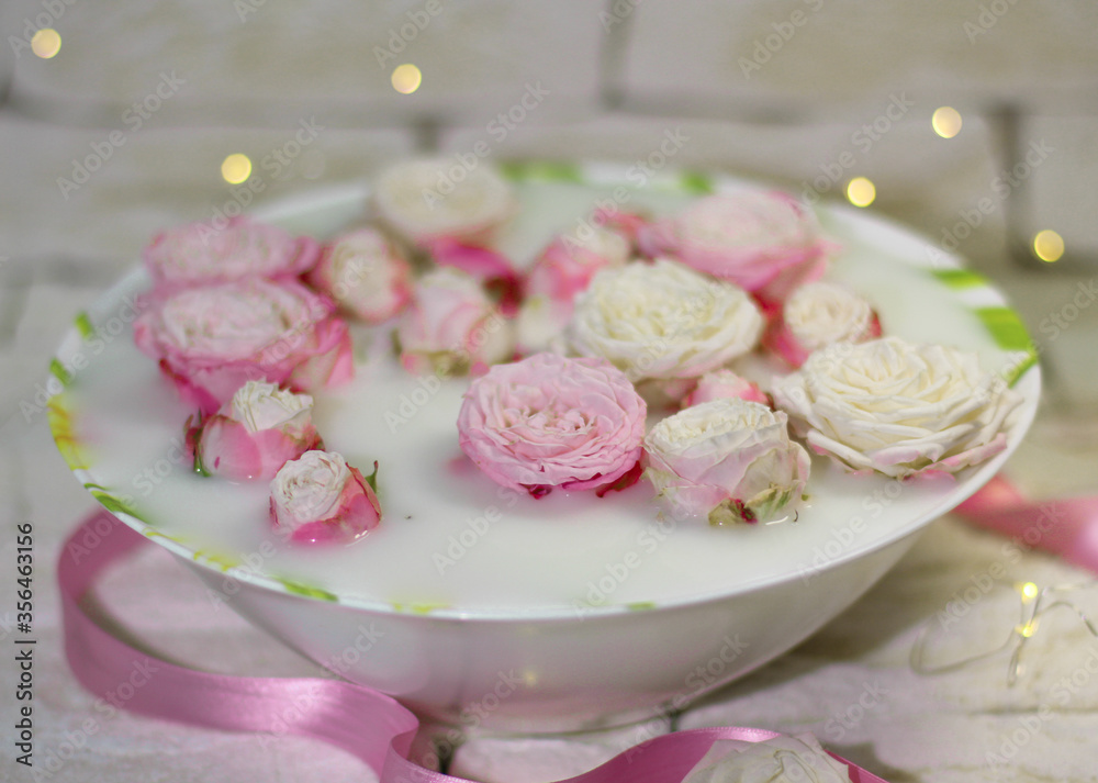 Plate with pink roses in milk water Plate with pink roses in milk water