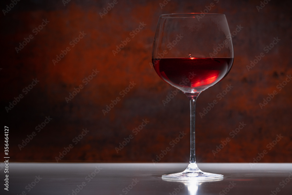 Glass or red wine against a rustic background