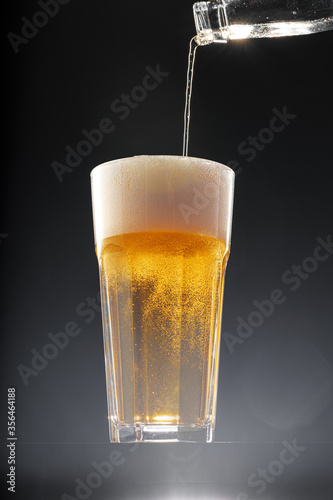 Wallpaper Mural Beer pouring into glass on black background Torontodigital.ca