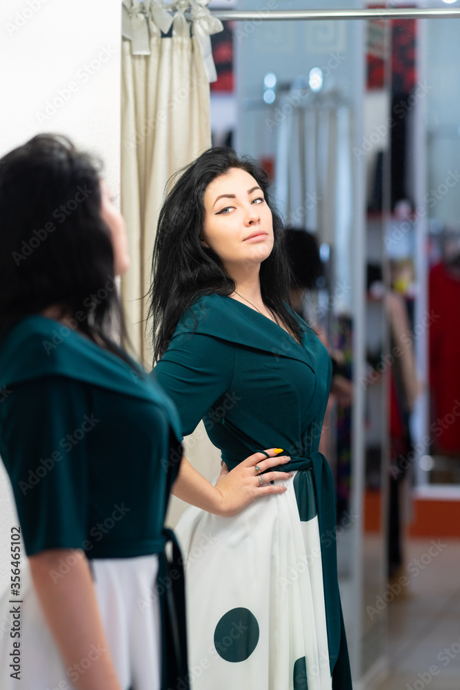 Attractive woman trying on new clothes