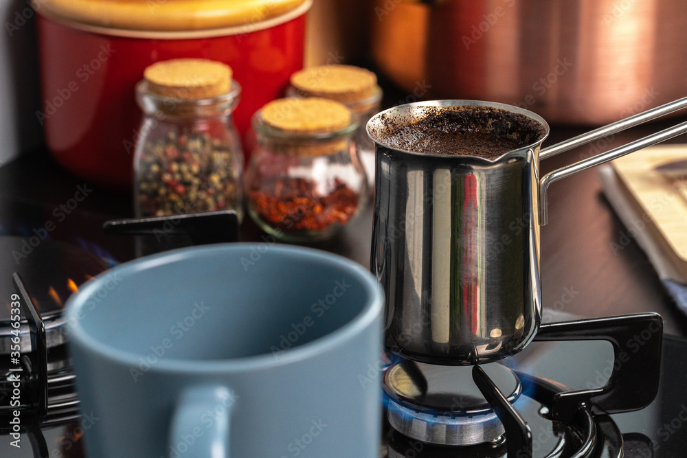 Brew coffee in a steel turk on a gas stove Brew coffee in a steel turk on a gas stove