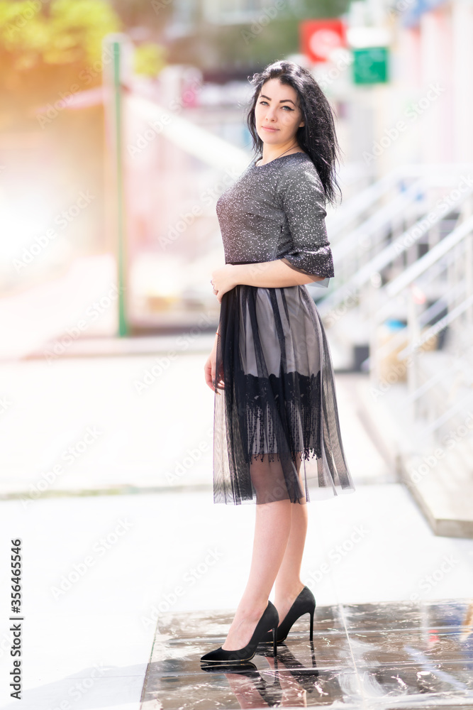 Fototapeta premium Stylish woman in an elegant black outfit