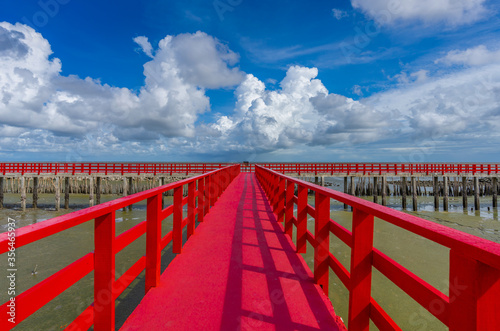 The red bridge and cloudy blue sky background. bridge cross the sea  Samutsakhon province Thailand