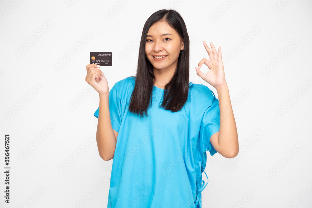 Young Asian beautiful woman patient holding personal accident insurance credit card and ok sign isolated on white background, PA and health claim services concept Young Asian beautiful woman patient holding personal accident insurance credit card and ok sign isolated on white background, PA and health claim services concept