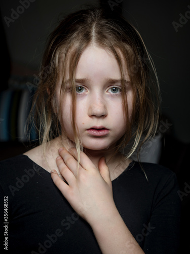 Pensive portrait of a schoolgirl. A tense and serious expression. © 31etc