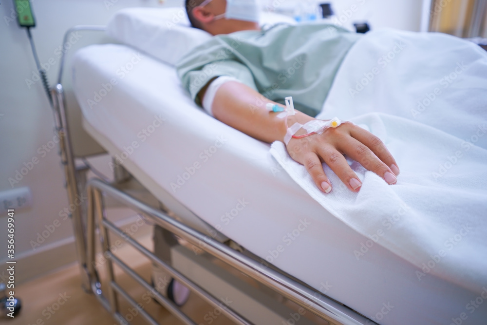 Fotka „soft focus Patients man quotes in hospital sleeping in the bed of a  ill sick person, patient rests and saline solution tube intravenous iv drip  inserted and stand waiting for the