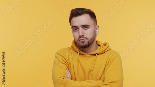 Expressive young man over vibrant background. Studio portrait of borred person. photo