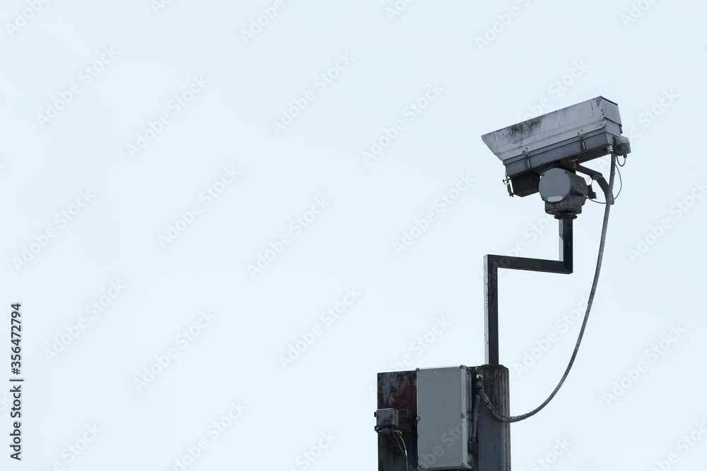 CCTV camera in sky watching people on street