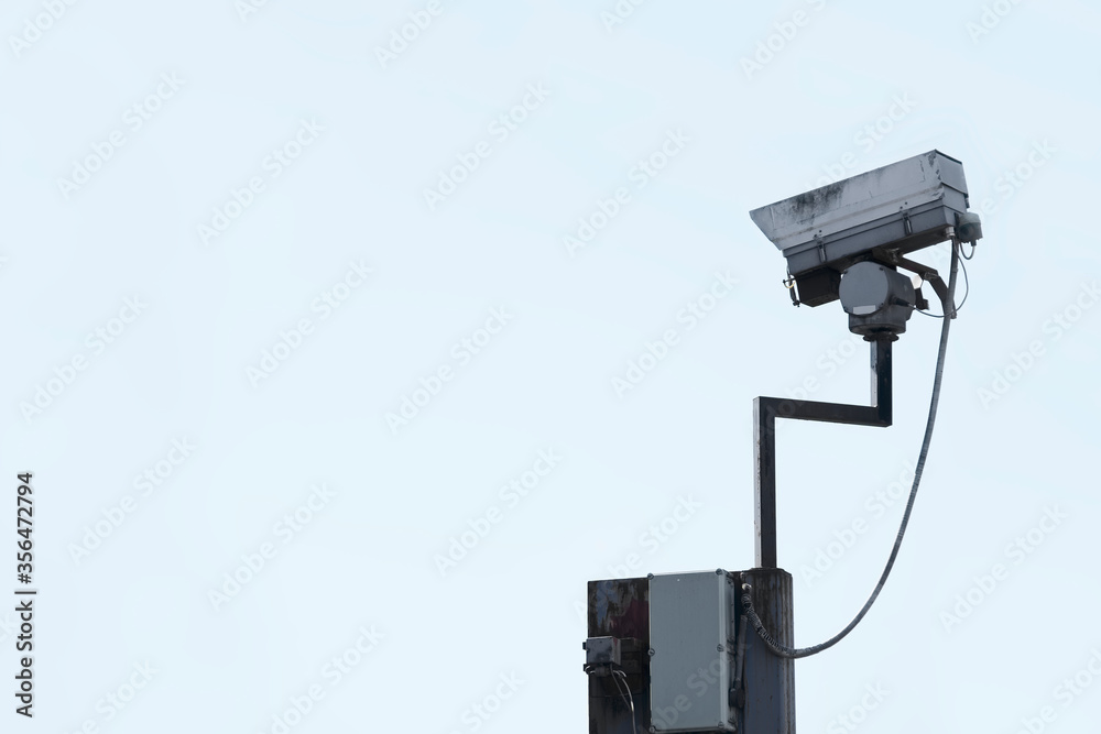 CCTV camera in sky watching people on street CCTV camera in sky watching people on street