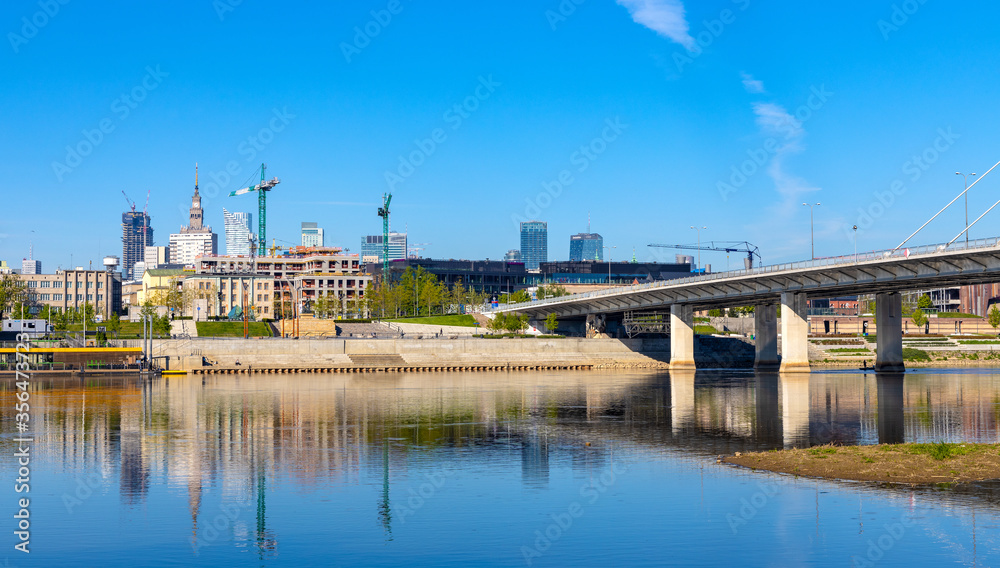 Panoramic view of Srodmiescie city center downtown quarter with Swietokrzyski Bridge - Most Swietokrzyski - over Vistula river in Warsaw, Poland