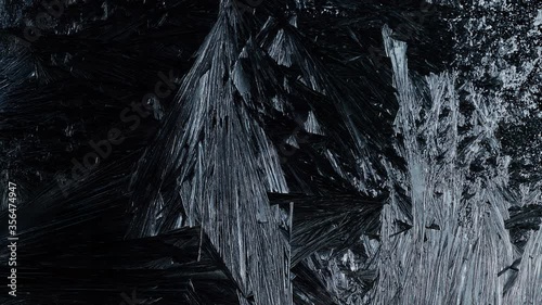 Ice Forming process 4K, Window freezing on dark background. Ice growind with dots and spikes