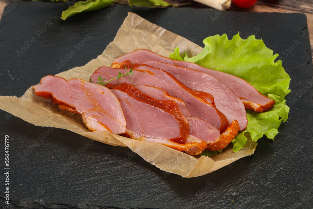 Sliced smoked duck breast served salad