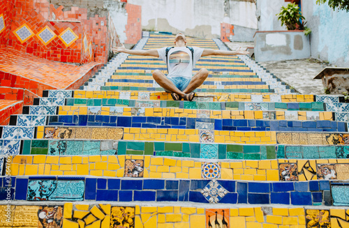 Turist sit on the colors stairs. View from the bottom of the stairs Selaron, one of the most visited places in Rio de Janeiro.  multi-colored tiles from more than 60 countries
