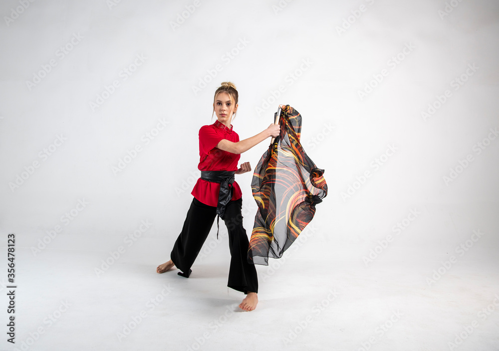 beautiful girl in black and red dancing with a combat scarf